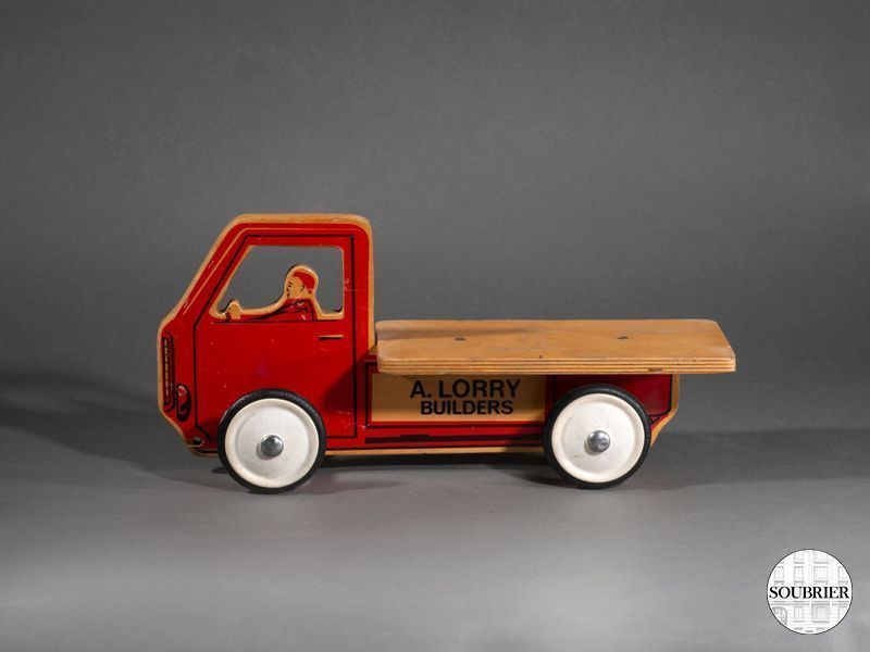Petite silhouette de camion bois rouge à roulette
