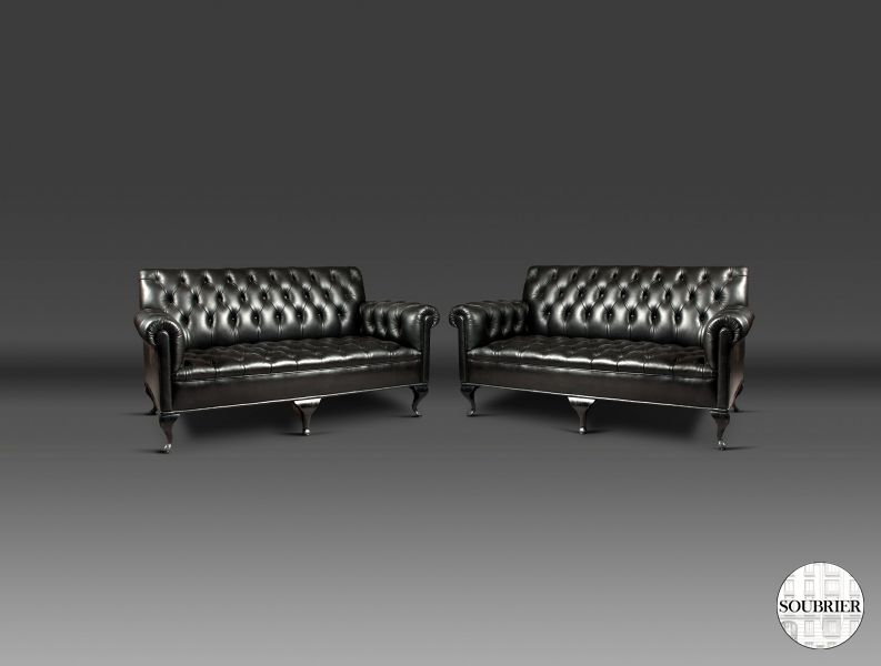 Pair of black Chesterfield sofas
