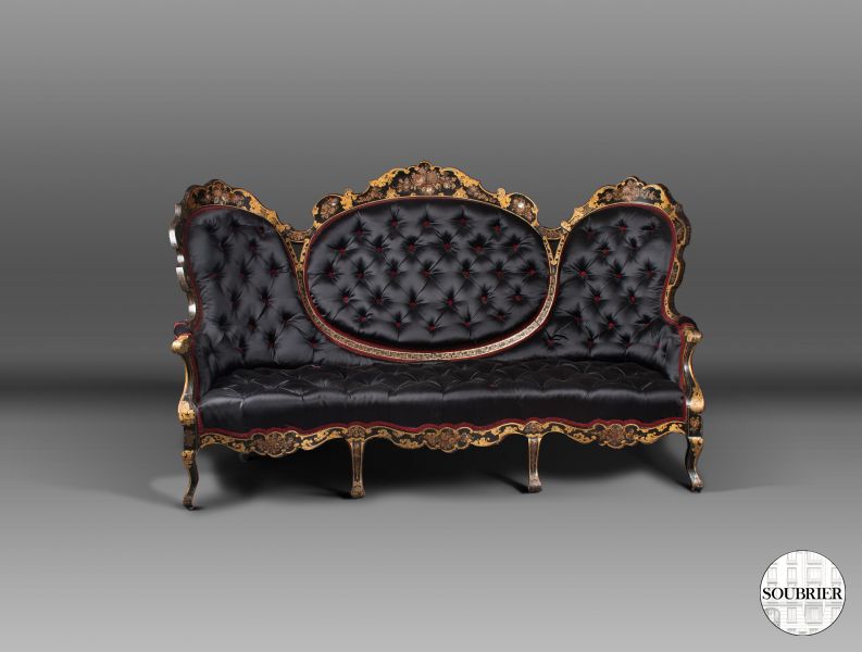 Gold and black upholstered sofa