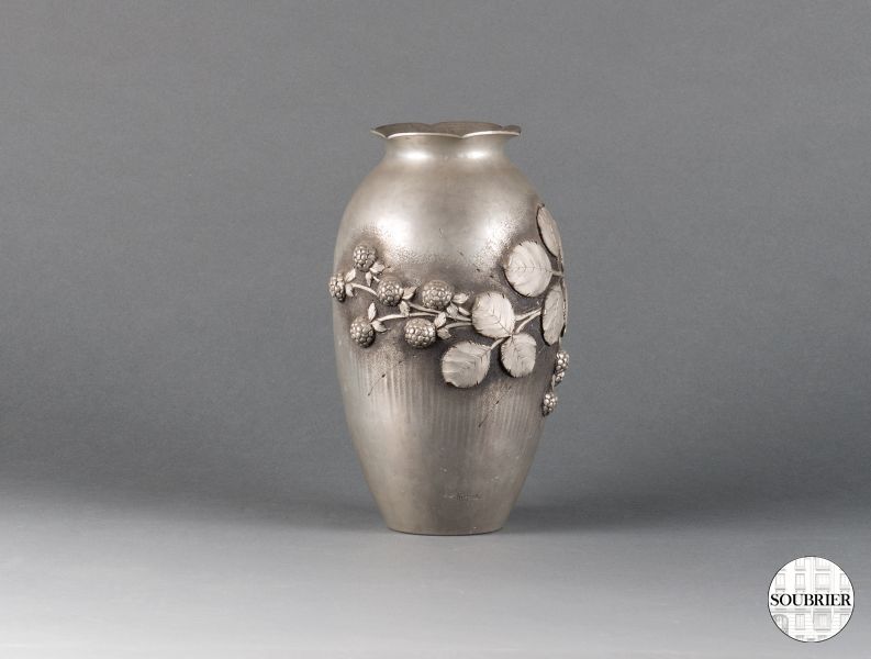 Hammered tin vase with flowers