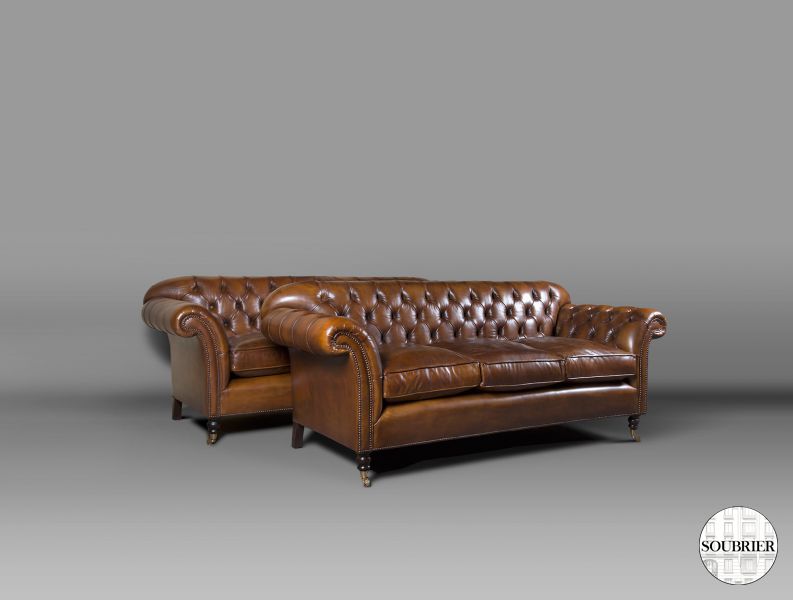 Two brown chesterfield sofas