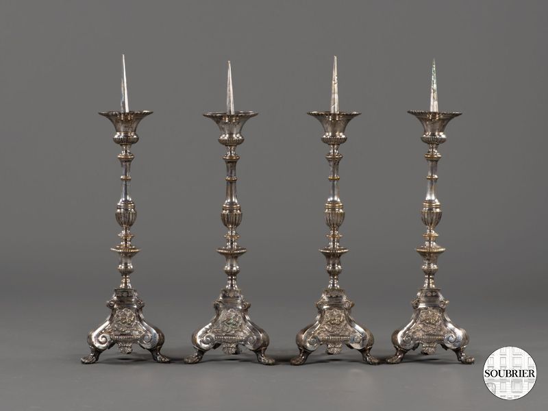 Four large silver-plated candlesticks